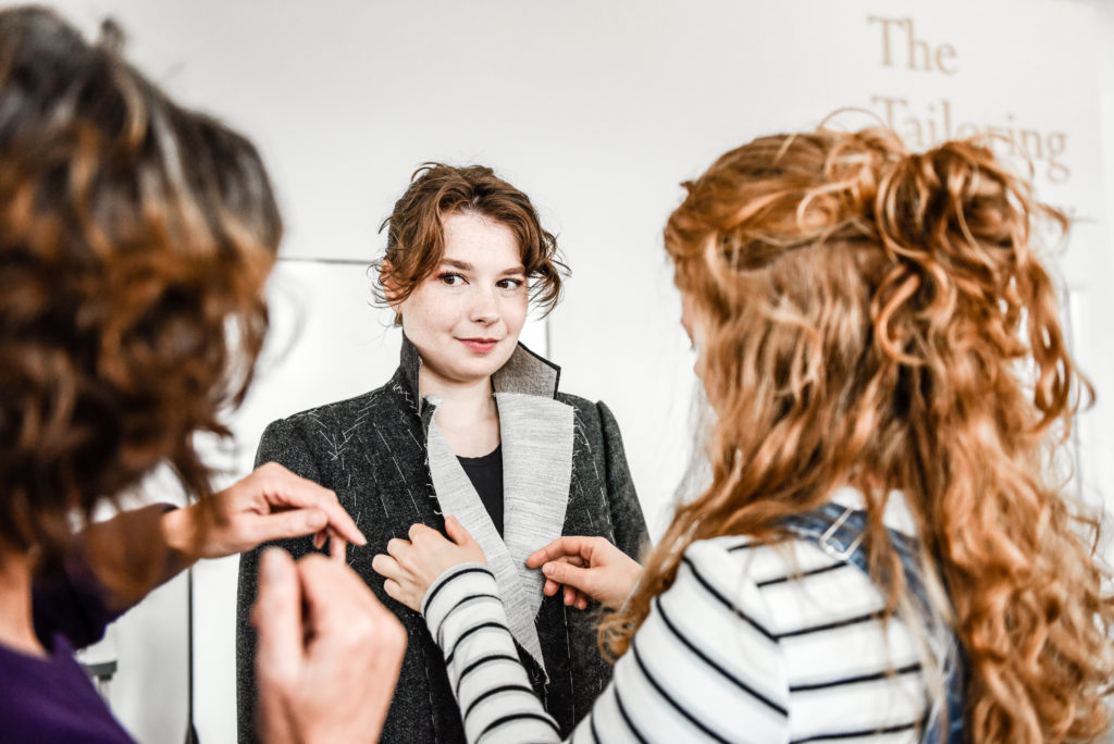 Image shows student learning to fit a bespoke jacket